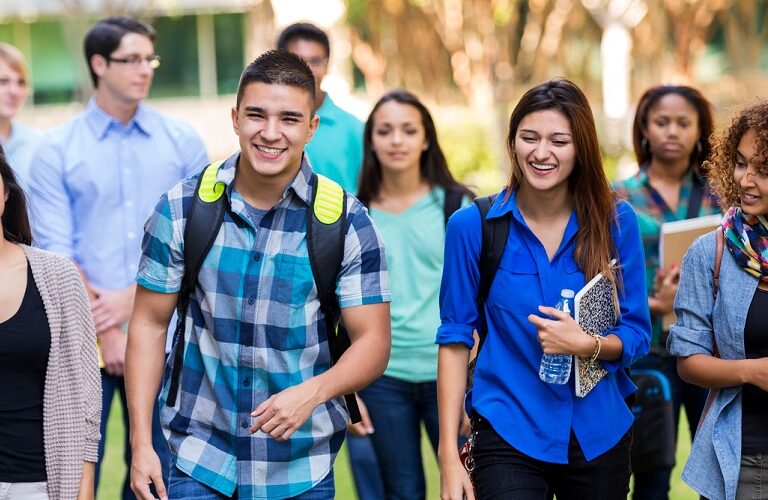 A group of teenagers or walking to school