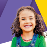 A smiling young girl with multi-coloured gradient background.